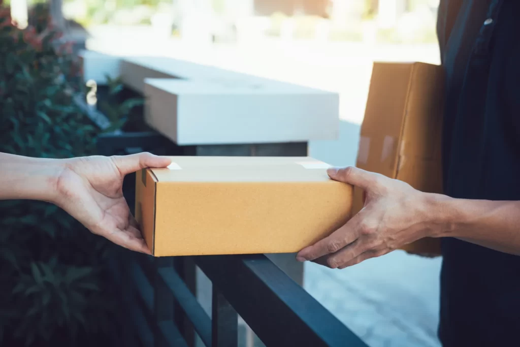 asian smart man handing giving a package to a cust utc